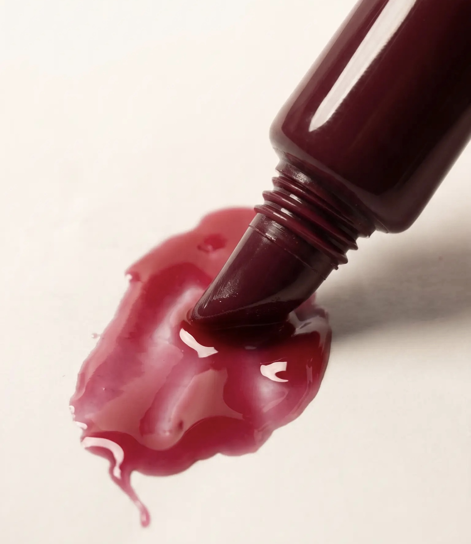 Burgundy Cherri Theory gloss tube with a high-shine cherry-coloured swatch